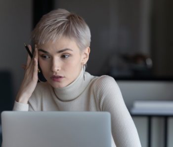 Businesswoman sitting at workplace search solution having problem feels confused