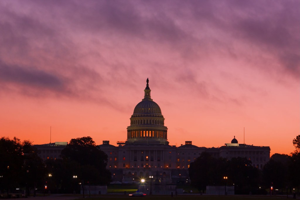 Alarmingly bright sunrise above US Capitol Dome. U.S. Capitol Dome Restoration project is nearing its completion.