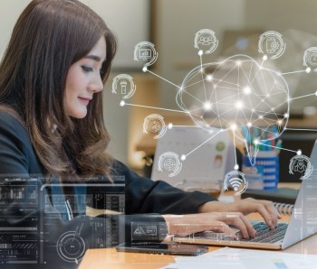 Asian businesswoman in formal suit working with computer laptop for Polygonal brain shape of an artificial intelligence with various icon of smart city Internet of Things, AI and business IOT concept