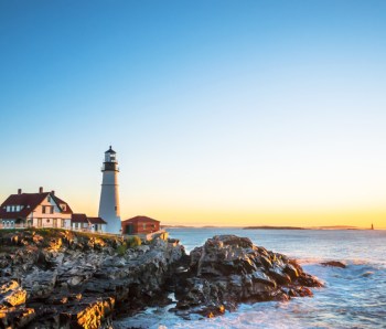 Portland Head Lighthouse at Fort Williams, Maine at sunrise over the Atlantic